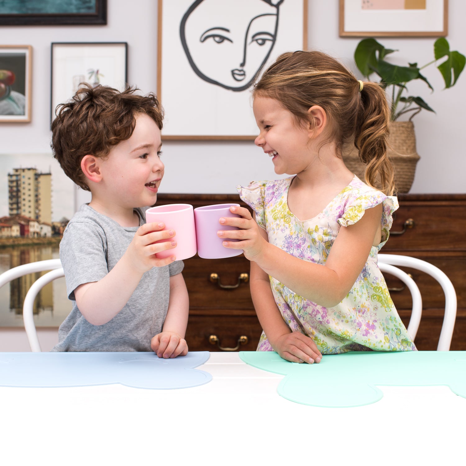 Two toddlers drinking from silicone cups