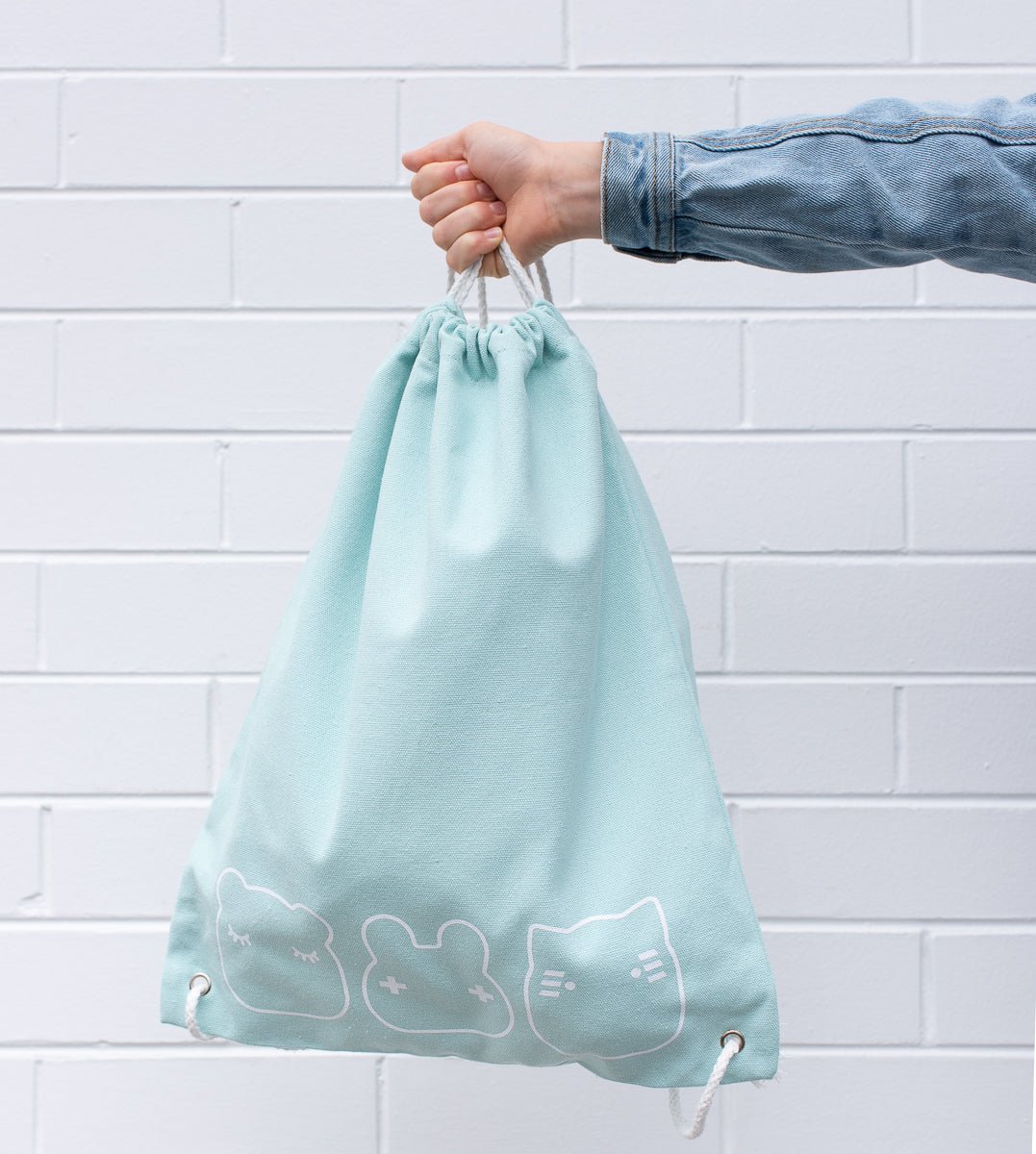 we-might-be-tiny-drawstring-canvas-bag-sage